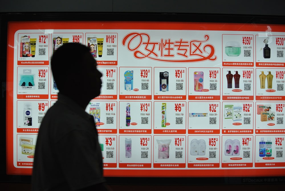 Man walking past billboard